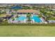Aerial view of a clubhouse with dual swimming pools, lounge area, and other amenities, offering a resort-like experience at 13859 Vadini St, Venice, FL 34293