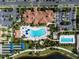 Aerial view of clubhouse with ample parking, resort style pool with a lagoon shape, and lap pool at 13859 Vadini St, Venice, FL 34293