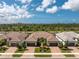 Aerial view of a neighborhood showcasing well-maintained homes, lush greenery, and a scenic waterfront setting at 13859 Vadini St, Venice, FL 34293