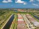 Aerial view showcasing a neighborhood with waterfront homes, lush landscaping, and scenic surroundings at 13859 Vadini St, Venice, FL 34293