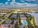 Aerial view of tennis courts, parking, community pool, and beautiful landscaping in a residential area at 13859 Vadini St, Venice, FL 34293