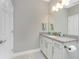 Bathroom featuring granite countertops, white cabinets, and modern lighting at 13859 Vadini St, Venice, FL 34293