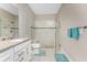 Bathroom featuring granite countertops, white cabinets, and a modern glass shower at 13859 Vadini St, Venice, FL 34293