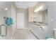 Bright bathroom featuring a dual vanity with granite countertops and a glass-enclosed shower at 13859 Vadini St, Venice, FL 34293