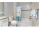 Bright bathroom featuring a shower and bathtub combination, white tile, and blue accents at 13859 Vadini St, Venice, FL 34293