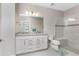 Bathroom with dual vanity, granite countertops, and a glass enclosed shower with a built-in bench at 13859 Vadini St, Venice, FL 34293