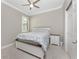 Cozy bedroom featuring a queen bed, ceiling fan, plantation shutters, and neutral decor at 13859 Vadini St, Venice, FL 34293