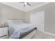 Comfortable bedroom with a queen bed, ceiling fan, and neutral color scheme at 13859 Vadini St, Venice, FL 34293