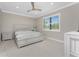 Bedroom with neutral walls, ceiling fan, white trim, and a view through the window at 13859 Vadini St, Venice, FL 34293