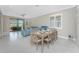 Bright dining area with modern furniture, seating for six, and tile floors at 13859 Vadini St, Venice, FL 34293