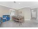 Dining room with seating for six, light tile floors, and modern decor at 13859 Vadini St, Venice, FL 34293