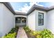 Charming entrance featuring a brick pathway, well-manicured landscaping, and a welcoming facade with modern windows at 13859 Vadini St, Venice, FL 34293