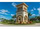 The community entrance showcases Mediterranean architecture and lush landscaping at 13859 Vadini St, Venice, FL 34293