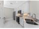 Modern kitchen showcasing stainless steel appliances, white cabinets, and a stylish backsplash with bright natural light at 13859 Vadini St, Venice, FL 34293