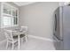 Bright breakfast nook area featuring a modern refrigerator and light-filled window at 13859 Vadini St, Venice, FL 34293