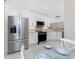 Well-equipped kitchen with stainless steel appliances, white cabinets, and a cozy breakfast nook at 13859 Vadini St, Venice, FL 34293