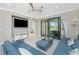 Open living area with a television, view of Primary bedroom and access to the patio at 13859 Vadini St, Venice, FL 34293