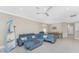 Bright living room featuring a large blue leather sofa and boat-themed decor at 13859 Vadini St, Venice, FL 34293