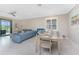 Open concept living and dining area with a sliding door to the outdoor patio at 13859 Vadini St, Venice, FL 34293