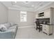 Cozy office space with a built-in desk, storage cabinets, natural light, and a comfortable sofa at 13859 Vadini St, Venice, FL 34293