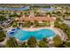 Resort-style pool with ample seating and palm trees offering a relaxing tropical oasis at 13859 Vadini St, Venice, FL 34293