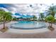 A Gathering friendly zero entry community pool is surrounded by comfortable lounge seating at 13859 Vadini St, Venice, FL 34293