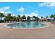 Large community pool surrounded by palm trees and lounge chairs under a bright blue sky at 13859 Vadini St, Venice, FL 34293