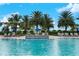 Community swimming pool with a fountain feature and lounge chairs on a sunny day at 13859 Vadini St, Venice, FL 34293