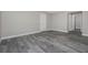 Bedroom features a neutral color palette, wood look tile flooring, and a doorway leading to a bathroom at 14 Current Ln, Placida, FL 33946
