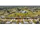 Aerial view of a cozy home nestled within a lush golf course community, surrounded by scenic ponds and green fairways at 146 Rotonda Cir, Rotonda West, FL 33947