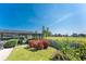 Landscaped backyard featuring a patio and views of the adjacent golf course at 146 Rotonda Cir, Rotonda West, FL 33947