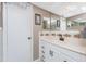 Bathroom featuring a vanity with a black faucet, framed mirrors, and cabinet storage at 146 Rotonda Cir, Rotonda West, FL 33947