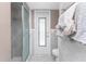 Bathroom features a glass-enclosed shower and a door leading to the exterior at 146 Rotonda Cir, Rotonda West, FL 33947