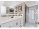 Bathroom boasts a stylish vanity with framed mirrors and a glass-enclosed shower stall at 146 Rotonda Cir, Rotonda West, FL 33947