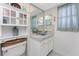 Bright bathroom features a decorative glass bowl sink, white cabinets, and mosaic tile backsplash at 146 Rotonda Cir, Rotonda West, FL 33947