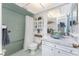 Bathroom featuring unique tiling, an intricately decorated sink, and an updated shower with glass doors at 146 Rotonda Cir, Rotonda West, FL 33947