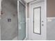Bathroom showcasing a glass-enclosed shower and a convenient door to the outside at 146 Rotonda Cir, Rotonda West, FL 33947