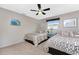 Bright guest bedroom offering two beds, windows for natural light, and a ceiling fan at 146 Rotonda Cir, Rotonda West, FL 33947
