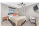Cozy bedroom with a ceiling fan, window, armchair, and mounted TV for relaxing comfort at 146 Rotonda Cir, Rotonda West, FL 33947