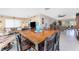 Open-concept dining area boasts a wooden table, tile floors, and seamless flow to the living spaces at 146 Rotonda Cir, Rotonda West, FL 33947
