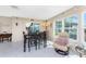 The bright dining area features tile flooring and large windows, creating an inviting and sunlit space at 146 Rotonda Cir, Rotonda West, FL 33947