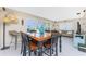 Dining space featuring tile floors, modern lighting, backyard views, and comfortable seating at 146 Rotonda Cir, Rotonda West, FL 33947