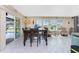 Bright dining room with tile flooring, large windows with backyard views, and sliding glass doors at 146 Rotonda Cir, Rotonda West, FL 33947