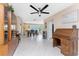 Open dining space with a ceiling fan, display cabinets, tile flooring, and an adjacent seating area at 146 Rotonda Cir, Rotonda West, FL 33947