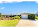 Charming single Gathering home with lush front yard landscaping and a one car garage at 146 Rotonda Cir, Rotonda West, FL 33947