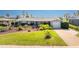Charming home featuring mature landscaping, a one-car garage and a well-manicured lawn at 146 Rotonda Cir, Rotonda West, FL 33947