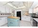 Well-lit kitchen with white cabinetry, black appliances, and an island for extra prep space at 146 Rotonda Cir, Rotonda West, FL 33947