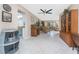 Open-concept living area with tile flooring, a decorative ceiling fan, and lots of natural light at 146 Rotonda Cir, Rotonda West, FL 33947