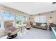 Inviting living room with tile floors, light-colored walls, comfortable seating, and sunny windows at 146 Rotonda Cir, Rotonda West, FL 33947