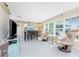Open-concept space featuring tile floors, dining area, and sunlit sitting areas with lush backyard views at 146 Rotonda Cir, Rotonda West, FL 33947